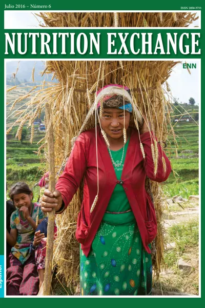 Front cover of issue 6 Spanish version of Nutrition Exchange. Image shows a woman walking with a stick and a bale of straw strapped to her back. 