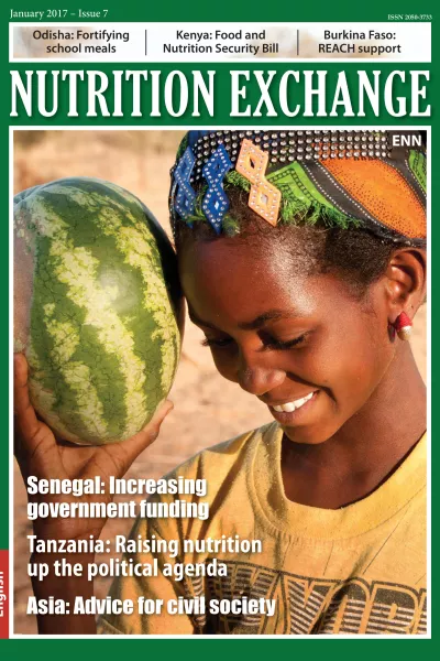 Front cover of issue 7 English version of Nutrition Exchange. Image shows a a girl smiling and holding a watermelon. 