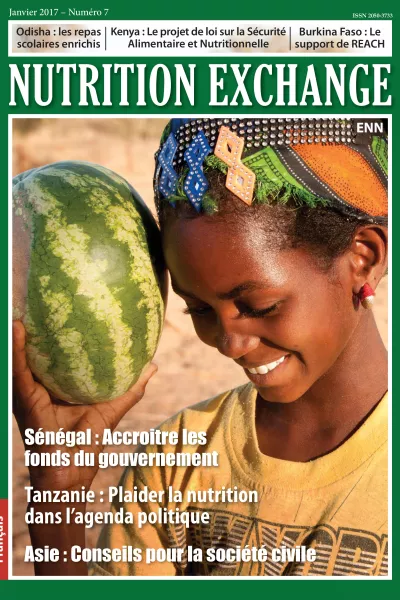 Front cover of issue 7 French version of Nutrition Exchange. Image shows a a girl smiling and holding a watermelon. 