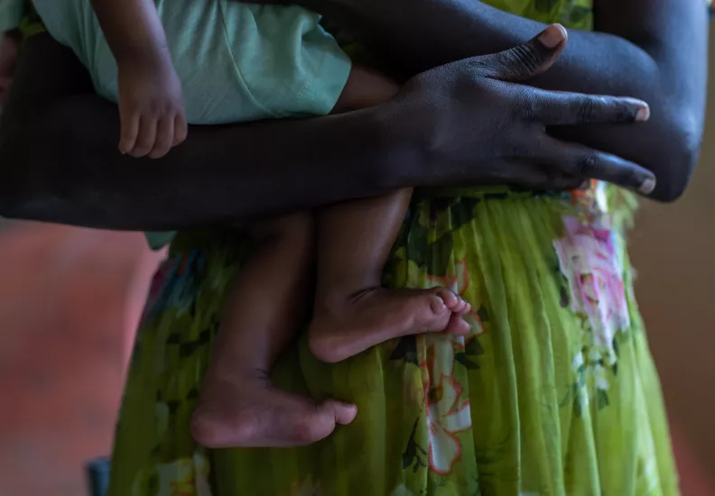 Woman holding a baby.